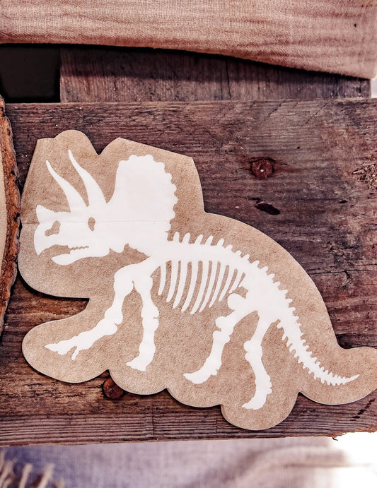 Détail du motif des serviettes dinosaures squelette tricératops