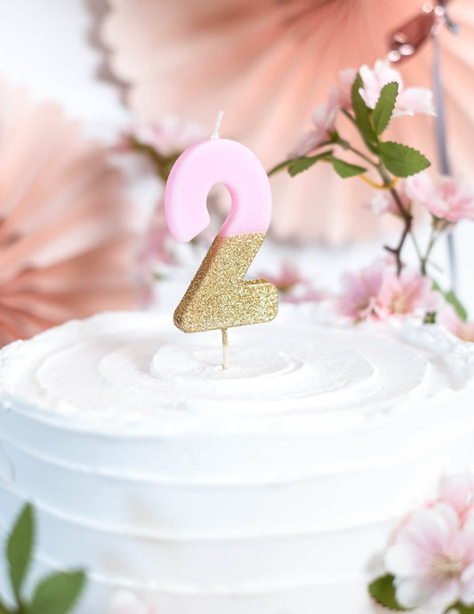 Gros plan sur le gâteau décoré de la bougie sur pique chiffre 2 pour gâteau