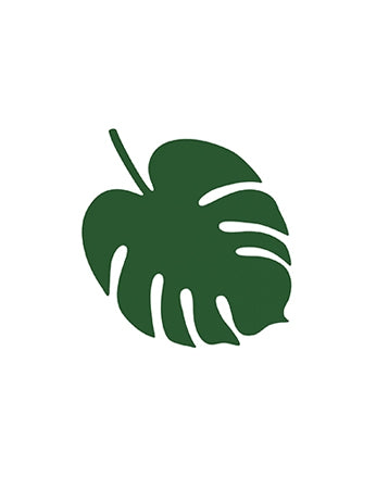 Mise en situation sur une assiette des décorations de table feuille Hawaï monstera
