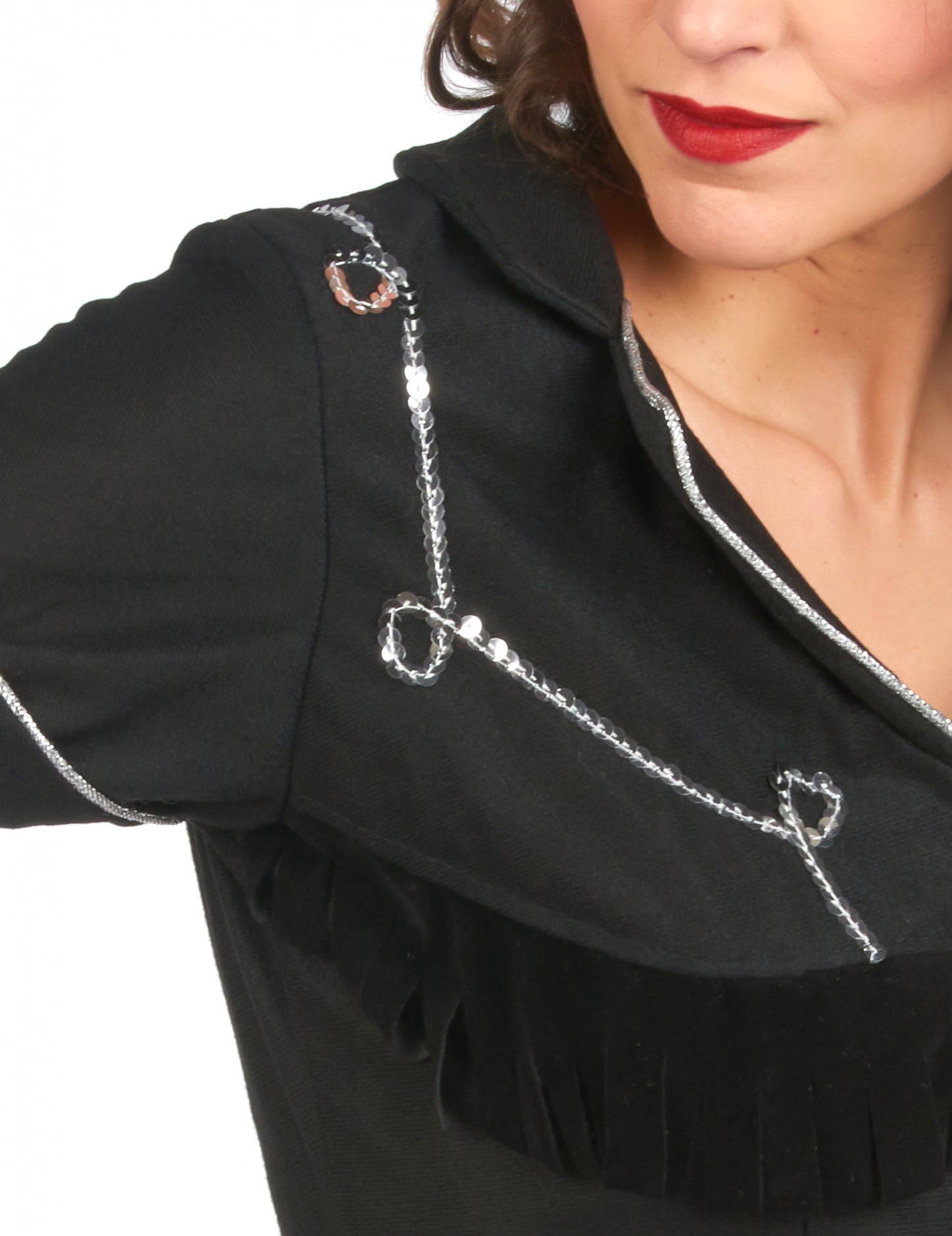 Détail des sequins argentés et des franges du déguisement de cow girl