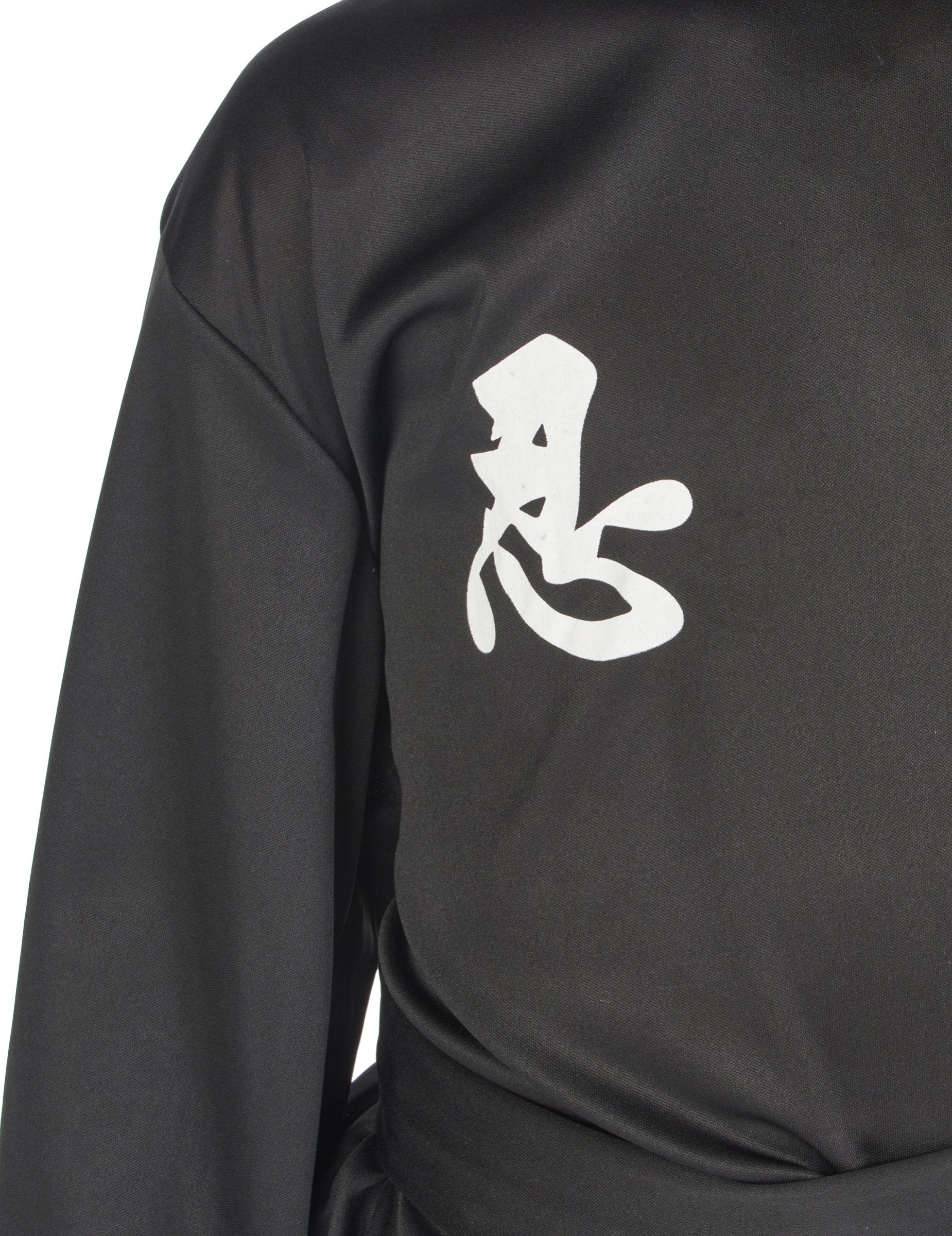 Részlet a fehér ideogrammról a ninja kommandós jelmez mellkasán