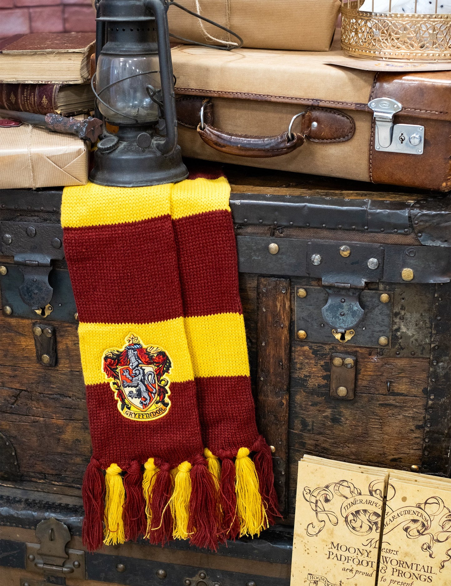 Mise en scène sur une malle de voyage de l'écharpe luxe Gryffondor