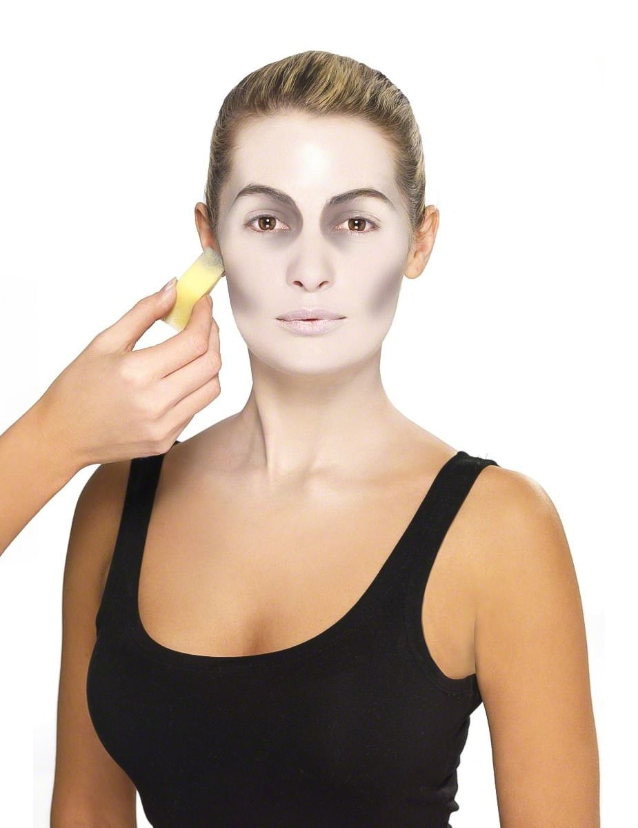 Application de la base blanche à l'éponge du kit maquillage vampire pour adulte Halloween