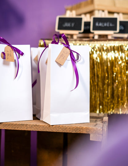 Mise en situation sur des sacs cadeaux du ruban satin violet